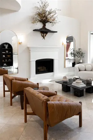 a living room with furniture and floor to ceiling windows