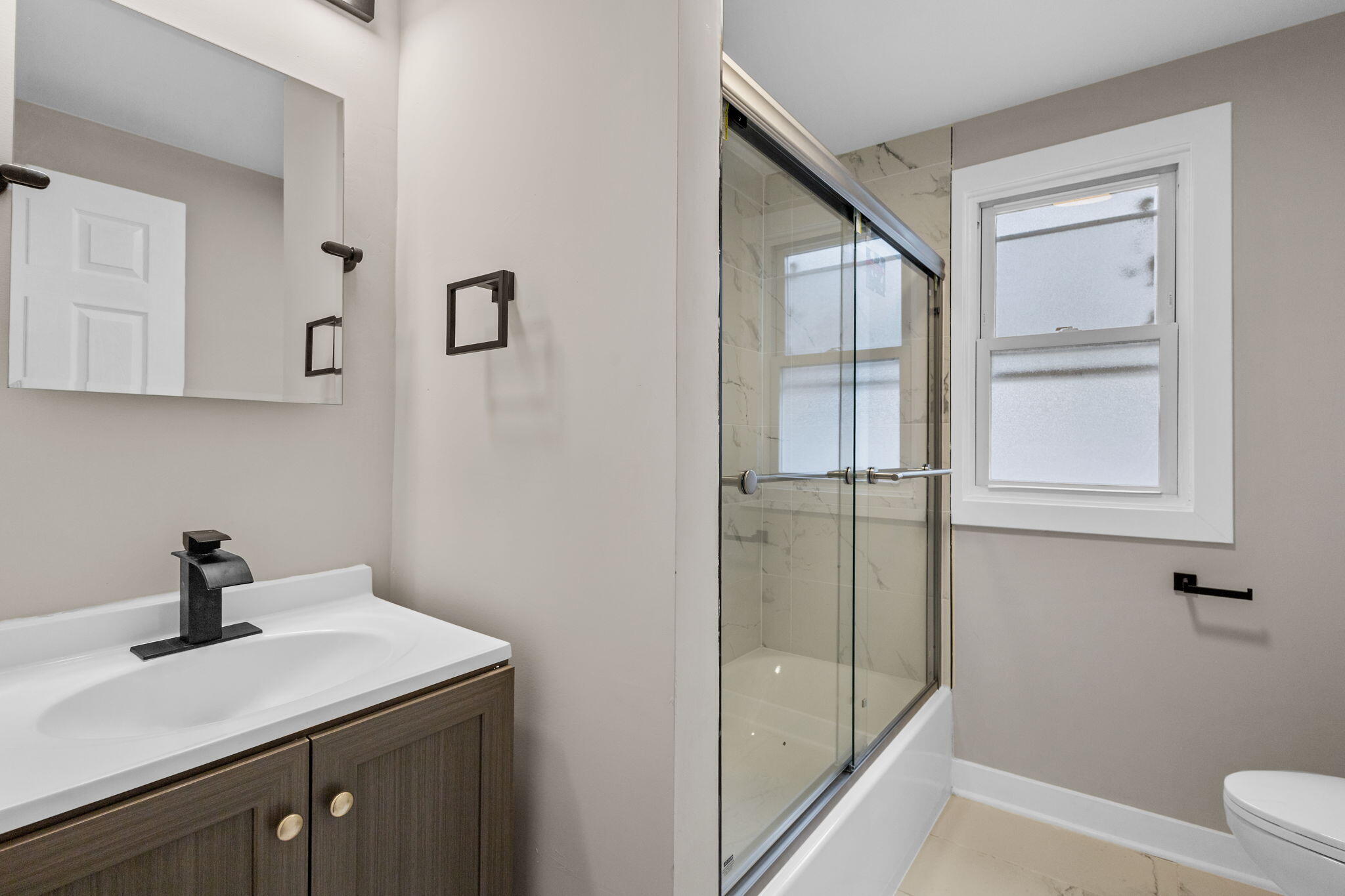 4680 Harrison Street Gary, IN 46408 - Photo 15 of 26 a bathroom with a sink a toilet and shower