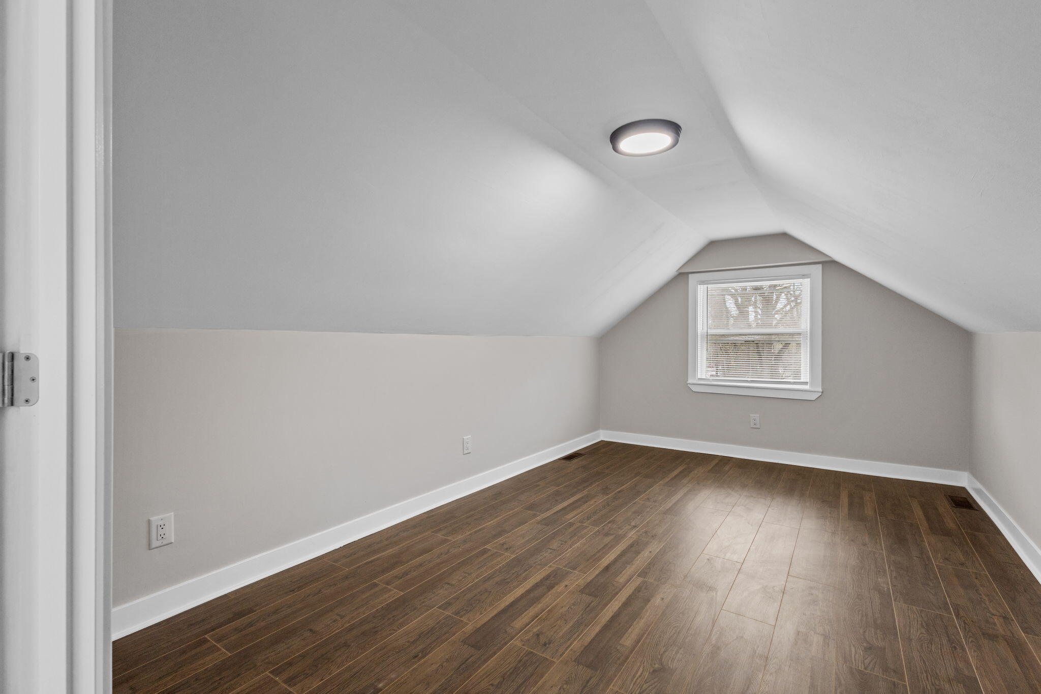4680 Harrison Street Gary, IN 46408 - Photo 17 of 26 an empty room with wooden floor and windows