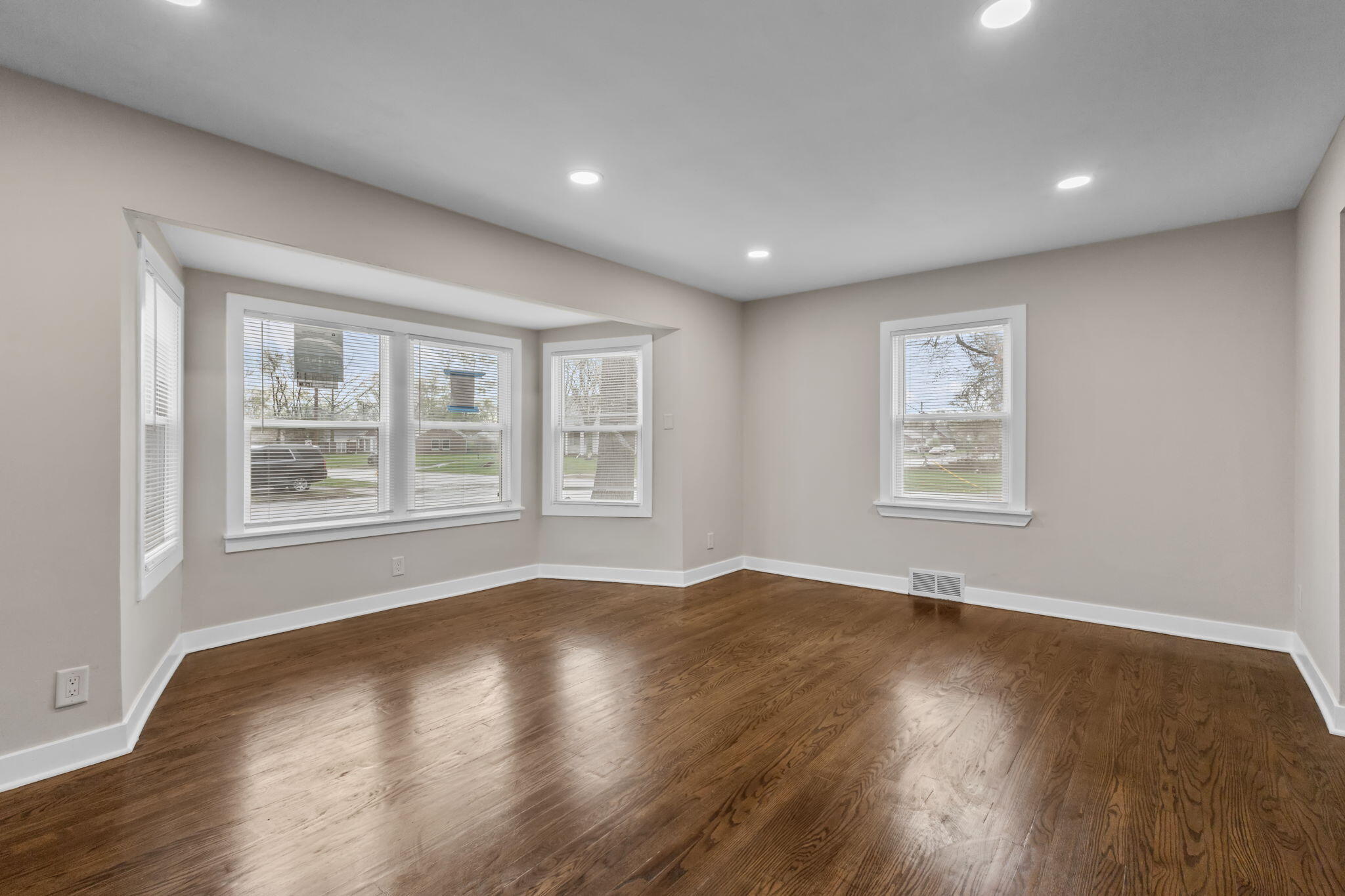 4680 Harrison Street Gary, IN 46408 - Photo 3 of 26 a view of empty room with wooden floor and fan