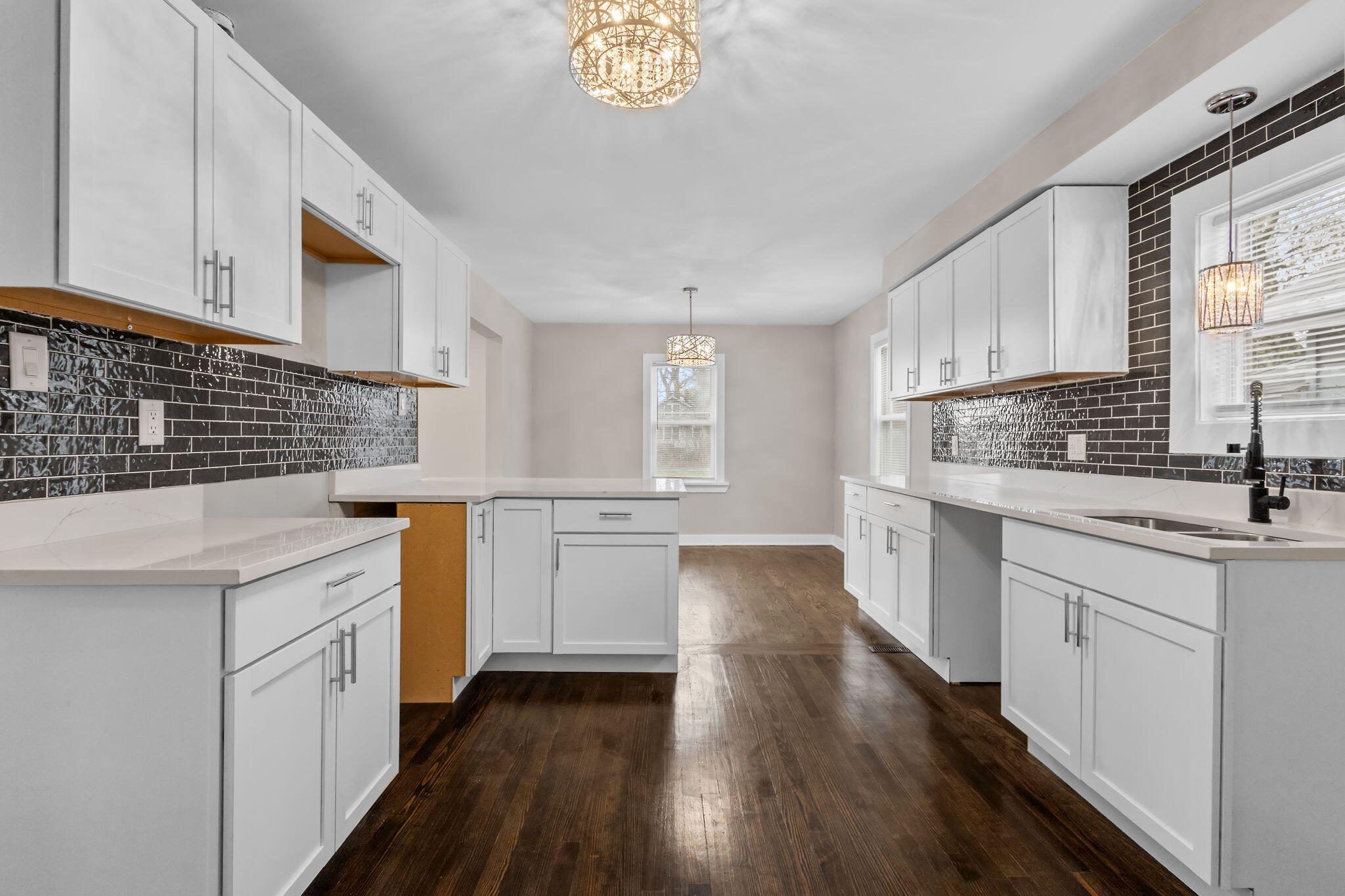 4680 Harrison Street Gary, IN 46408 - Photo 6 of 26 a kitchen with granite countertop a sink stove and cabinets