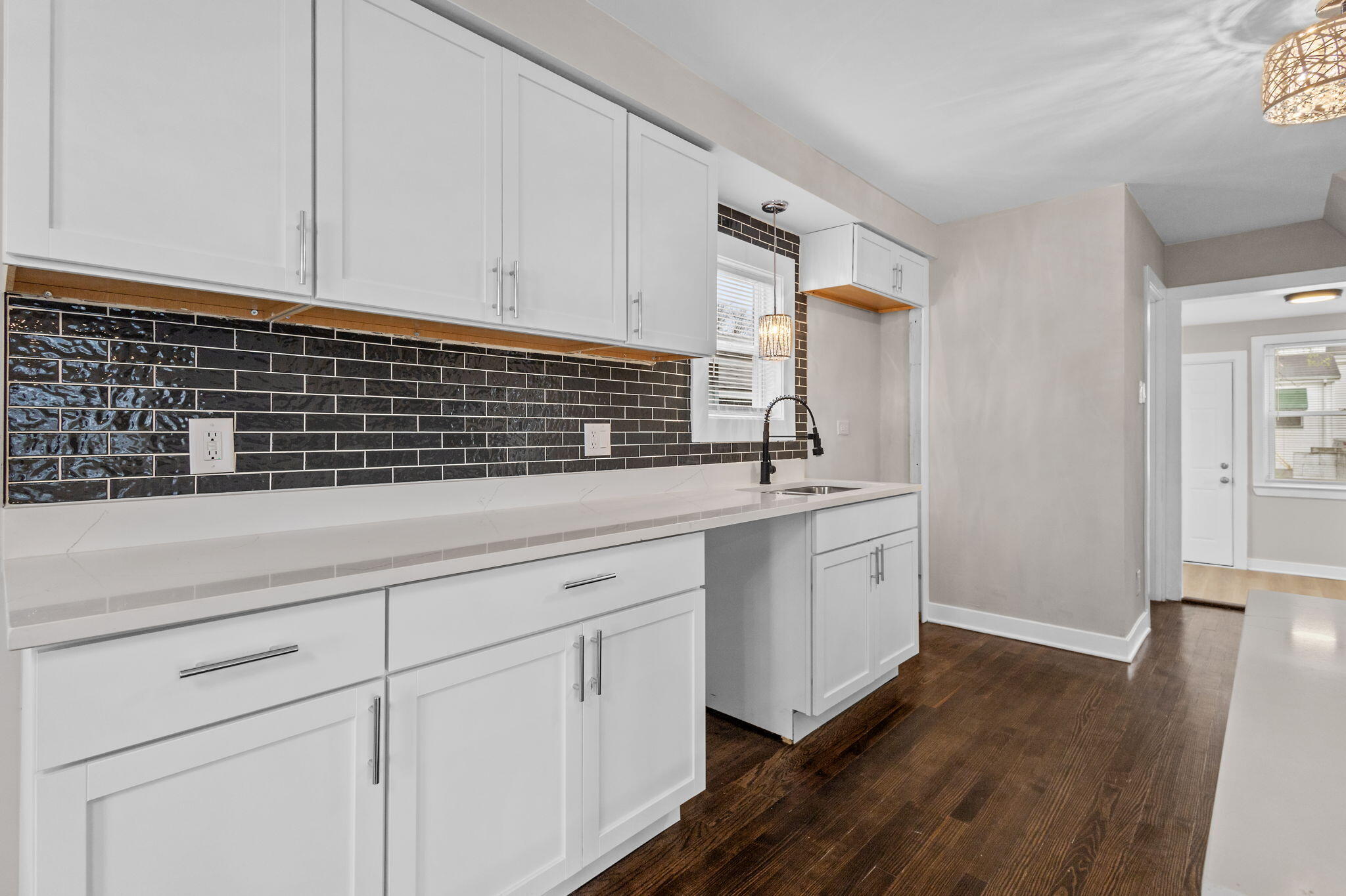 4680 Harrison Street Gary, IN 46408 - Photo 7 of 26 a kitchen with granite countertop white cabinets and white appliances