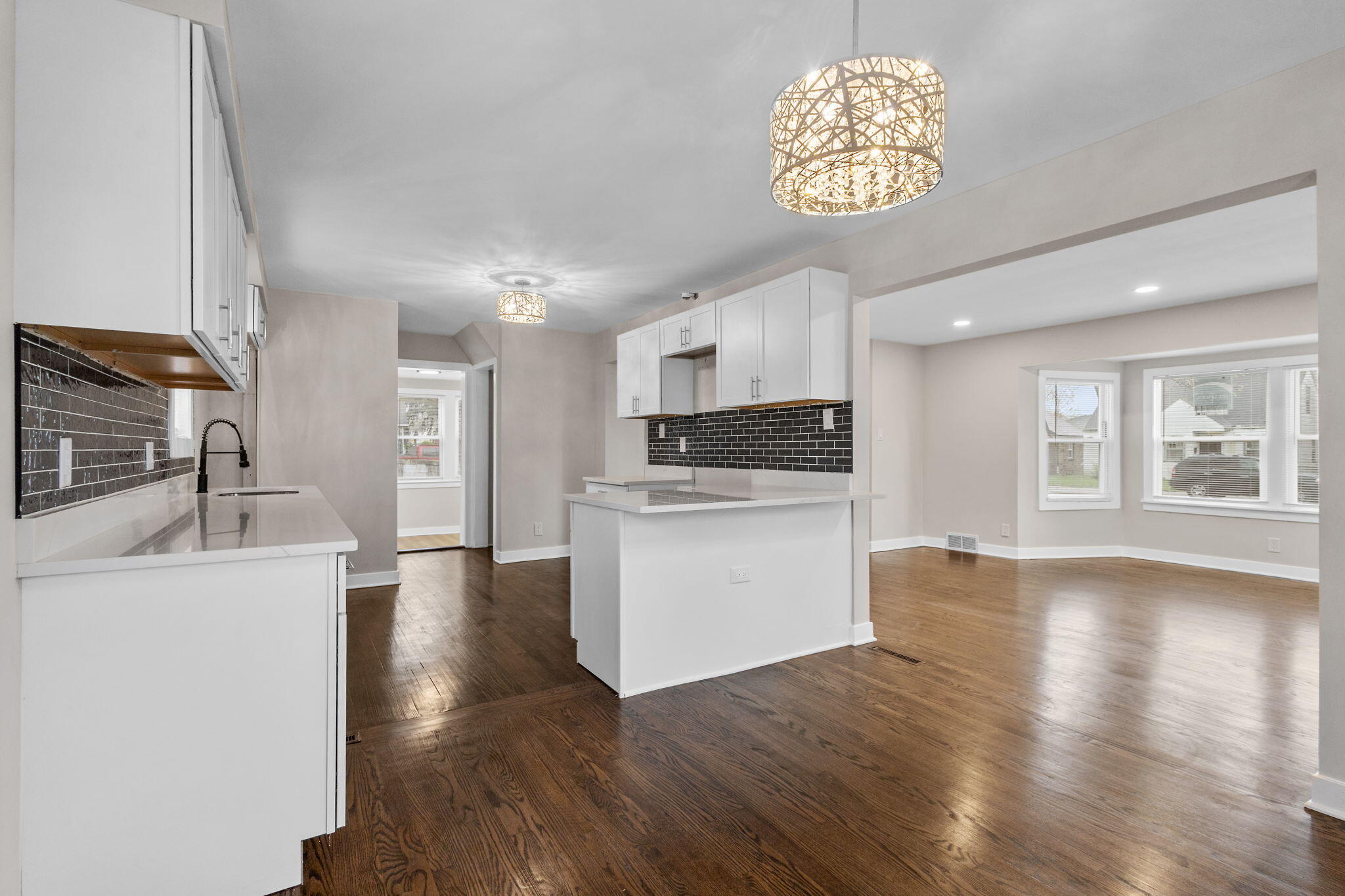 4680 Harrison Street Gary, IN 46408 - Photo 9 of 26 a kitchen with stainless steel appliances granite countertop a stove a sink dishwasher and a refrigerator with wooden floor
