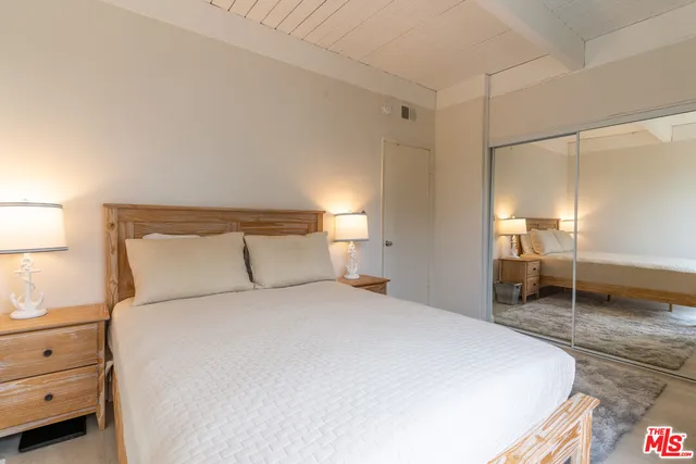 a bedroom with a bed and a cabinets