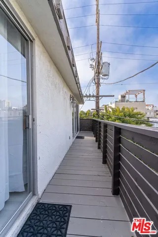 a view of a balcony with wooden floor