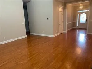 a view of a room with wooden floor and a window