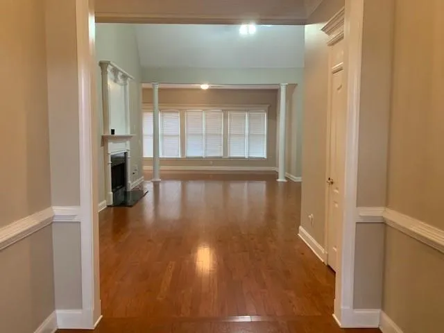 a view of interior space with wooden floor and windows