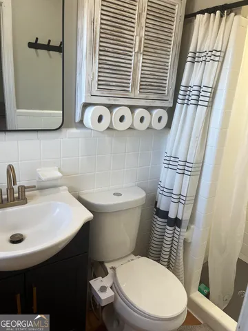 a white toilet sitting next to a bathroom sink