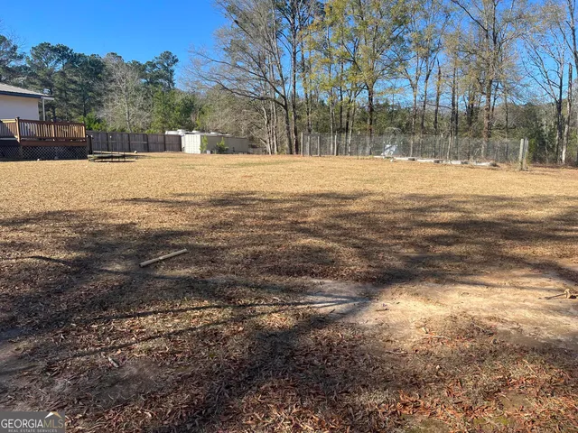 a backyard of a house with large trees