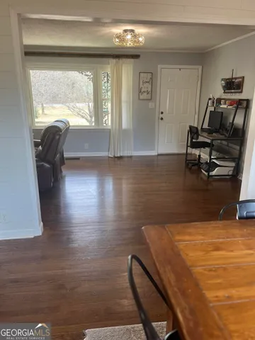 a view of a livingroom with furniture hardwood floor and a window