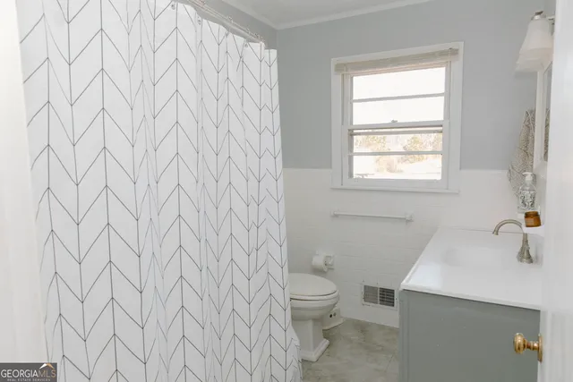 a bathroom with a toilet and sink