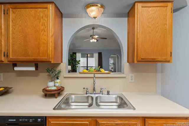 a kitchen with sink and cabinets