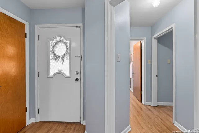 a view of a hallway with wooden floor