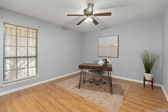 a workspace with wooden floor and a window