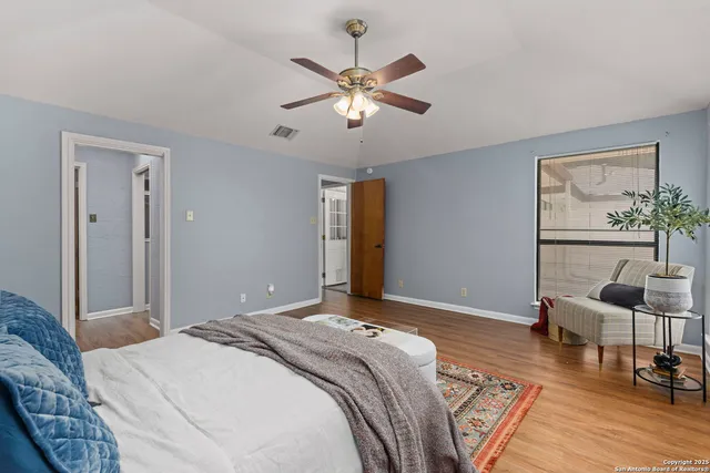 a bedroom with a large bed and a chandelier