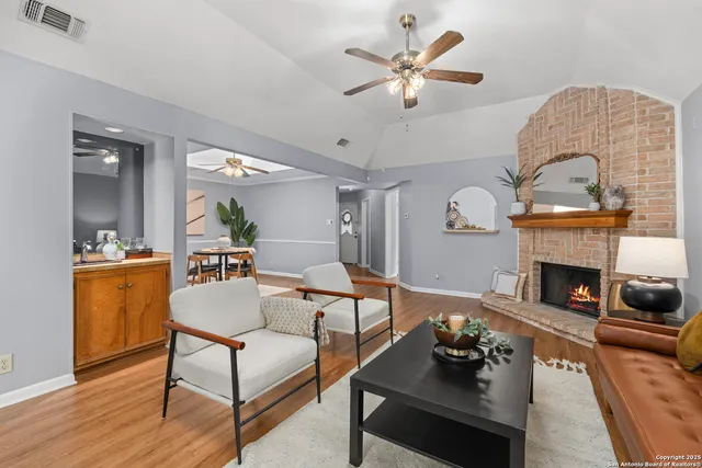 a living room with furniture and a fireplace