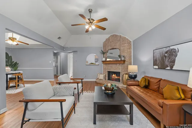 a living room with fireplace furniture and a chandelier