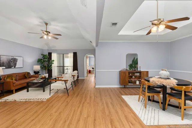 a living room with furniture and wooden floor