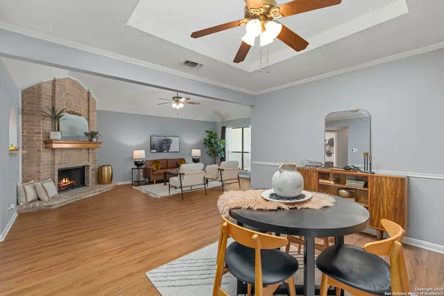 a view of a dining room with furniture and a fireplace