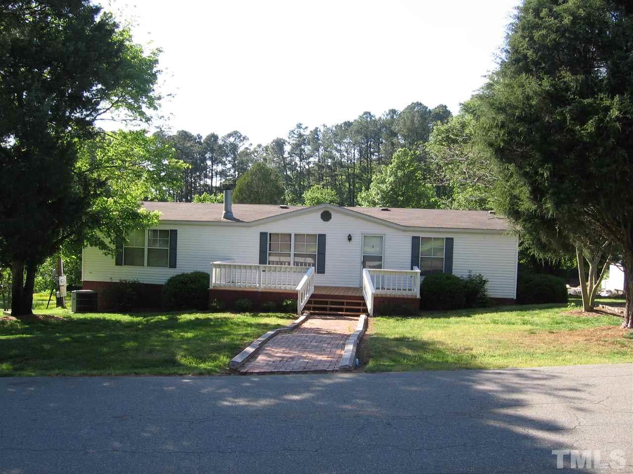 155 Charlie Fields Road Pittsboro, NC 27312 - Photo 1 of 25 Front of home before fence. Fence was installed as safe entry / exit for kids & pets from house to yard. Removal of fence can be negotiated.
