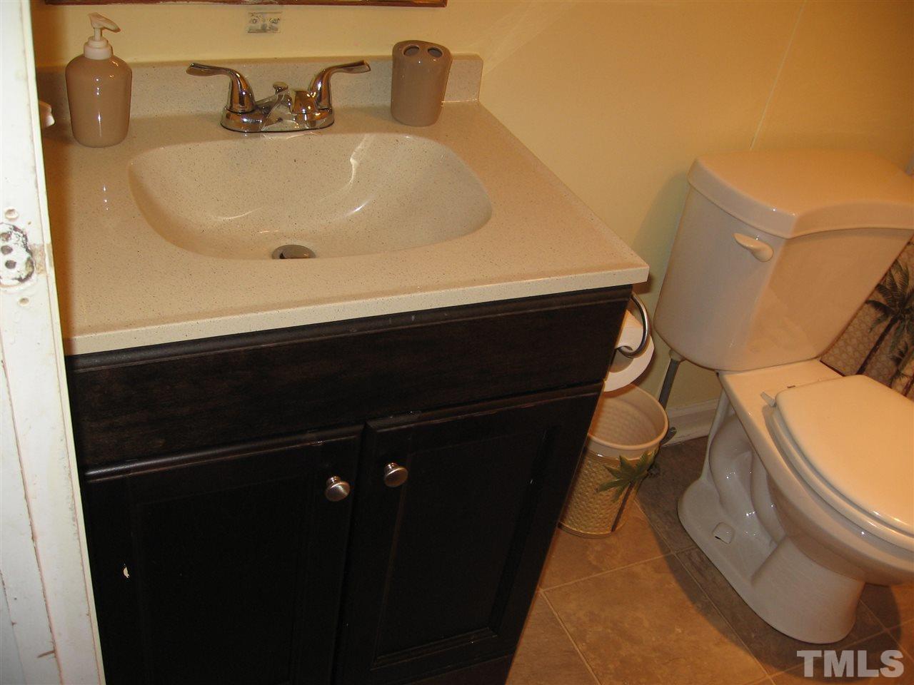 155 Charlie Fields Road Pittsboro, NC 27312 - Photo 15 of 25 2nd bathroom has new sink & cabinet & a combo shower/tub.