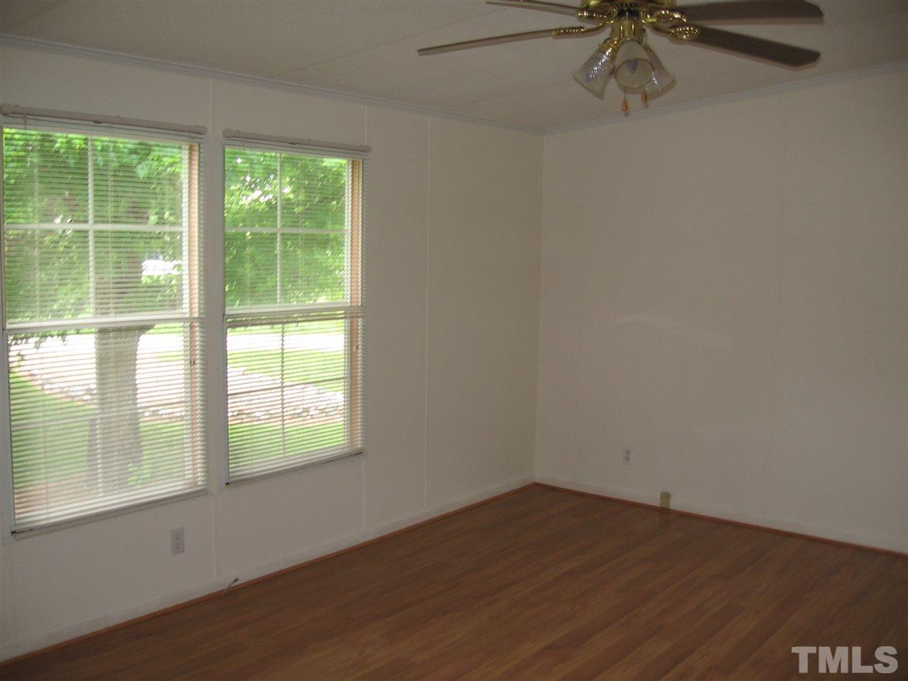 155 Charlie Fields Road Pittsboro, NC 27312 - Photo 17 of 25 Ex-large master (17x13) with walk in closet. Beautiful laminate wood flooring thruout home. Entry to bath & to living room. Master is opposite end of home from other two bedrooms. all bedrooms are big & have walk-in closets !