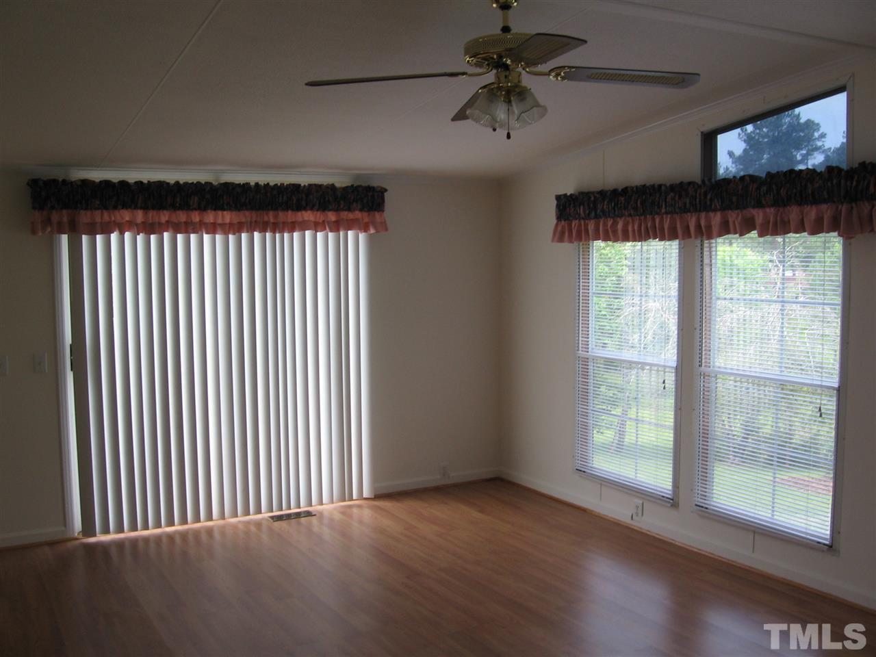155 Charlie Fields Road Pittsboro, NC 27312 - Photo 6 of 25 20x14 bonus/sun room. sliding doors to deck and large open entry to dining room / kitchen. Similar open entry from dining room to living room.