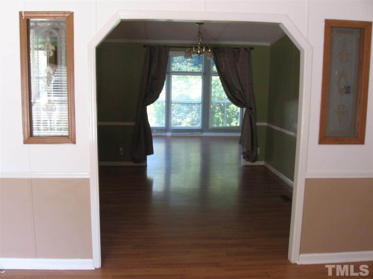 155 Charlie Fields Road Pittsboro, NC 27312 - Photo 7 of 25 large open entry from living rm to dining & continues thru to sun/bonus room.