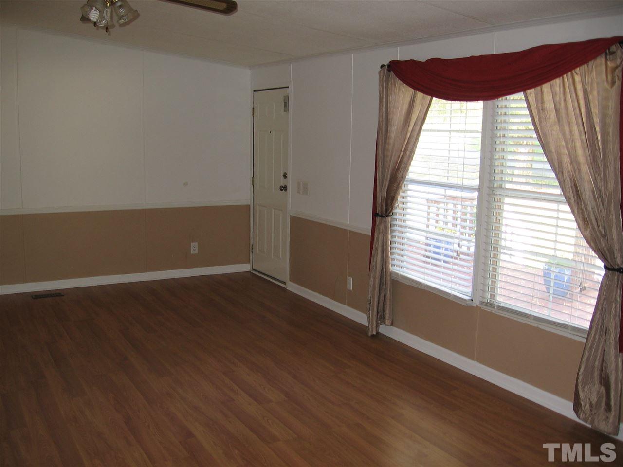 155 Charlie Fields Road Pittsboro, NC 27312 - Photo 10 of 25 living room view from master bedroom door. Door in distance in the front door that has a security system attached to it.
