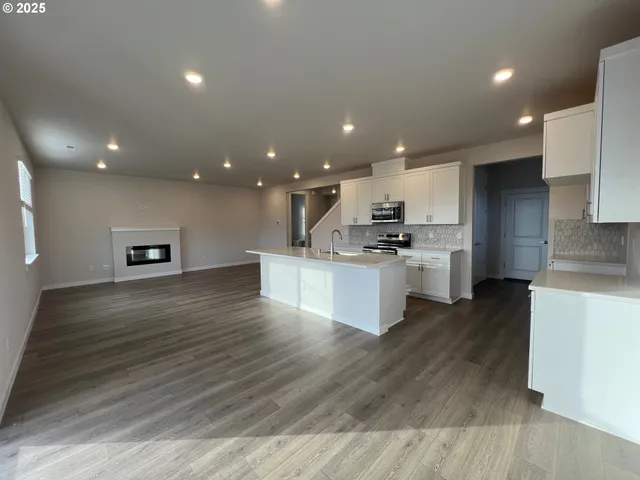 a view of kitchen with kitchen island microwave oven stove and oven