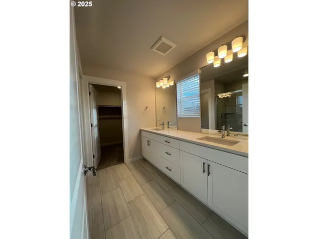 a large bathroom with a sink and a mirror