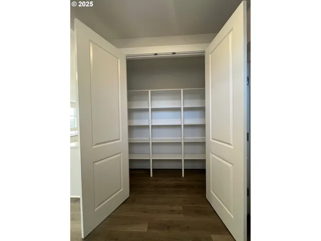 a view of a walk in closet and empty room