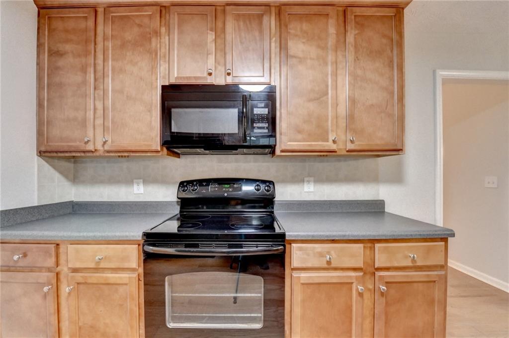 310 Andrew Ridge Drive Jefferson, GA 30549 - Photo 18 of 52 a kitchen with stainless steel appliances granite countertop white cabinets and a stove top oven with granite countertops