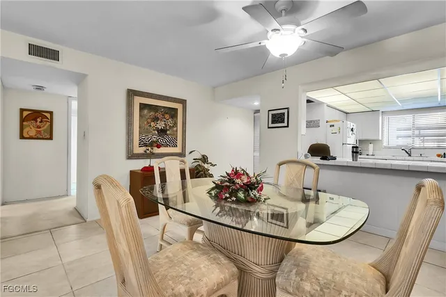 a dining room with furniture and a chandelier