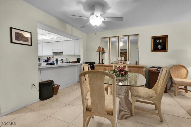 a view of a dining room with furniture and chandelier