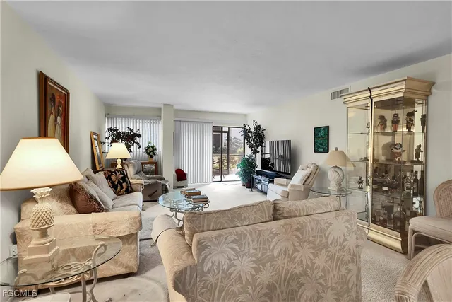 a living room with furniture and a lamp