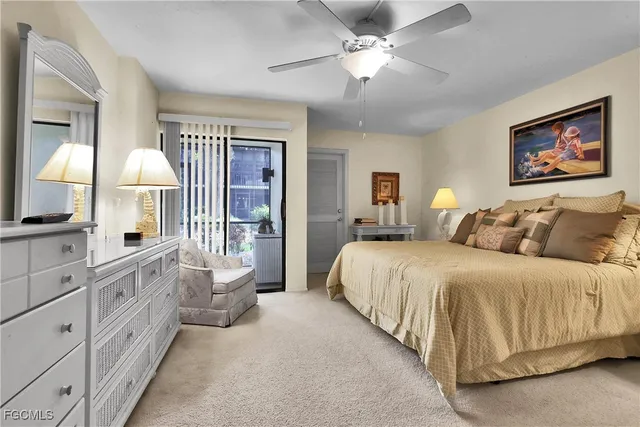 a spacious bedroom with a large bed and a chandelier