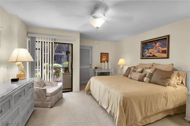 a spacious bedroom with a bed a couch and a chandelier