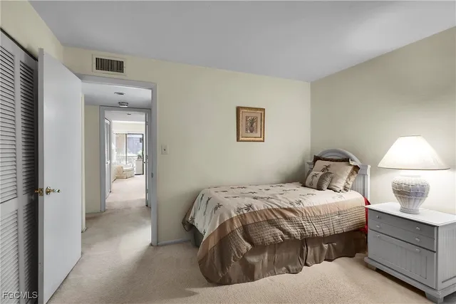 a bedroom with a bed and a lamp