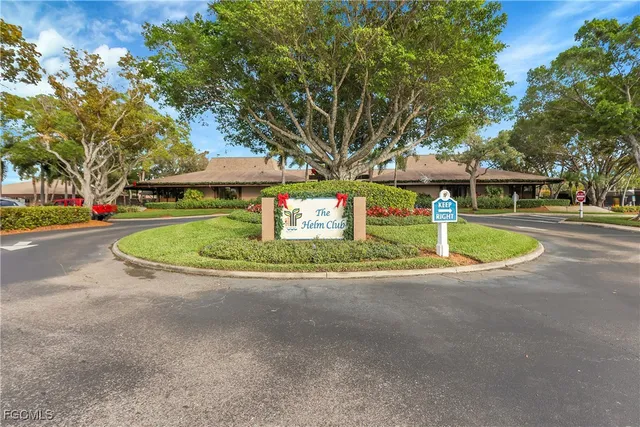 a front view of a house with swimming pool and next to a yard