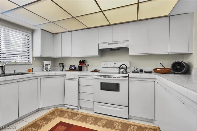 a kitchen with stainless steel appliances granite countertop a sink and cabinets