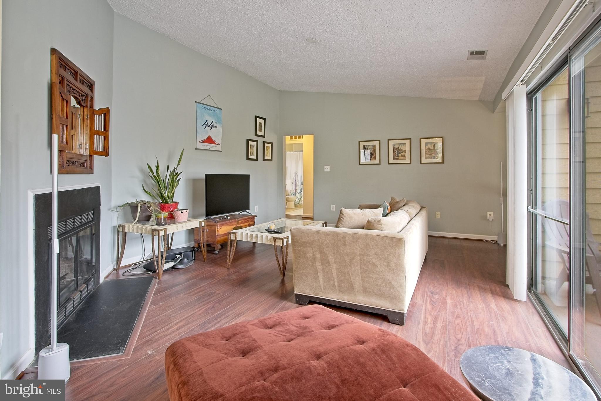 11045 Villaridge Court Reston, VA 20191 - Photo 7 of 38 Living room includes a wood-burning fireplace