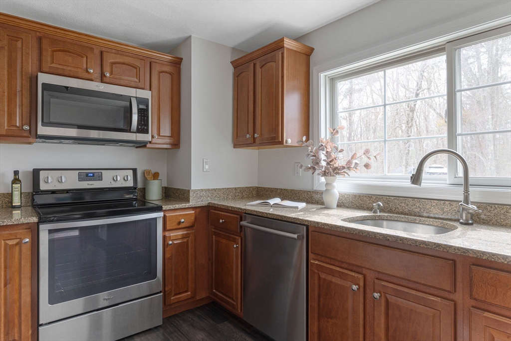 42 Swain Road Wilmington, MA 01887 - Photo 5 of 28 a kitchen with a sink stove and microwave
