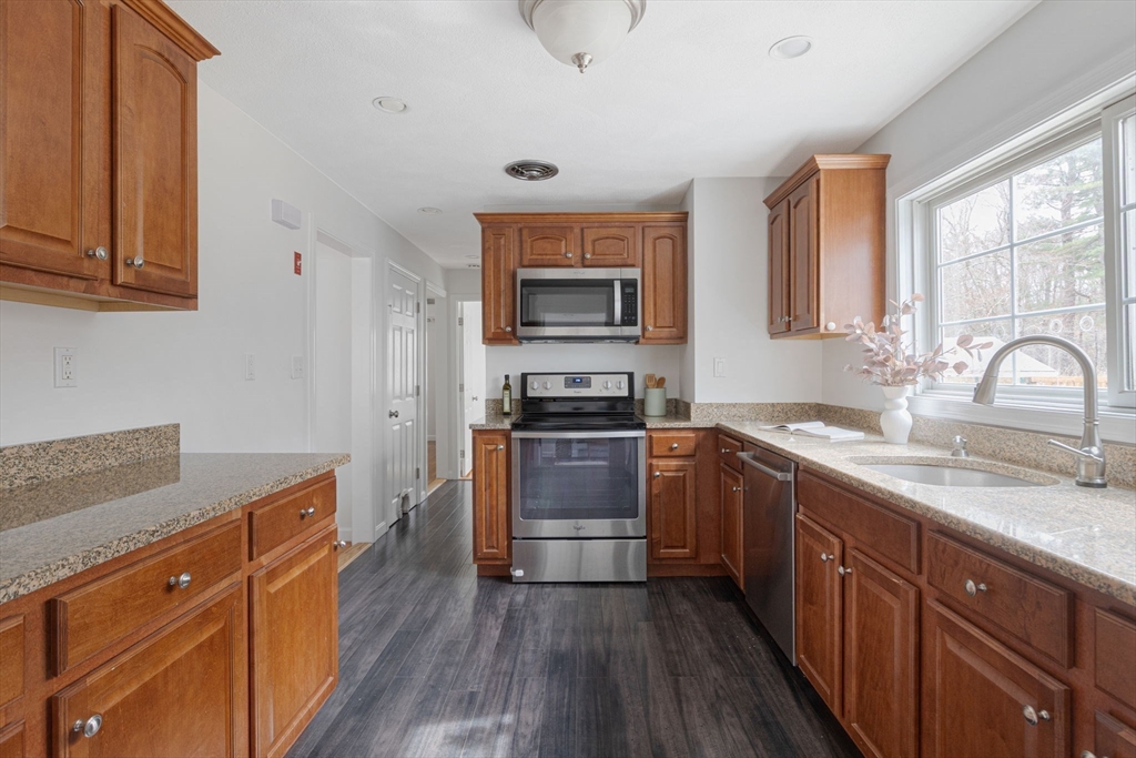 42 Swain Road Wilmington, MA 01887 - Photo 6 of 28 a kitchen with granite countertop a stove and a sink