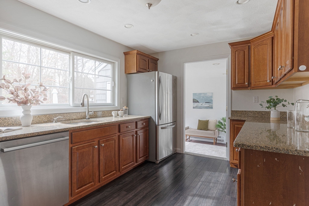 42 Swain Road Wilmington, MA 01887 - Photo 7 of 28 a kitchen with stainless steel appliances granite countertop a refrigerator and a sink