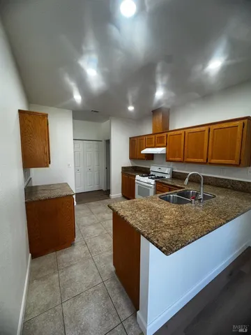 a kitchen with stainless steel appliances granite countertop a sink a microwave counter and chairs
