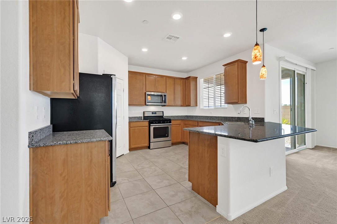 155 Fulgora Street Henderson, NV 89074 - Photo 5 of 30 A well-equipped kitchen boasts granite countertops and ample cabinetry, offering both functionality and style.