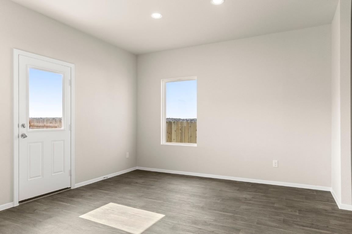 5409 Murano Cove Austin, TX 78747 - Photo 14 of 32 an empty room with wooden floor and windows