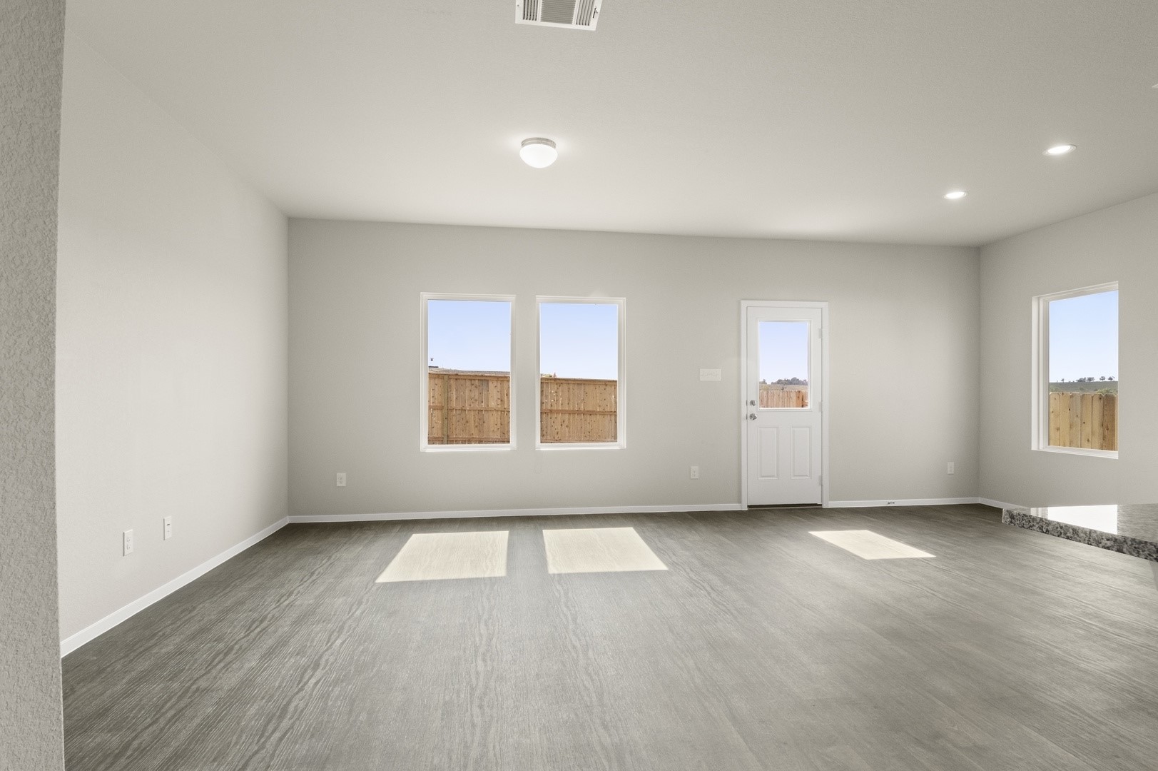 5409 Murano Cove Austin, TX 78747 - Photo 8 of 32 an empty room with wooden floor and windows