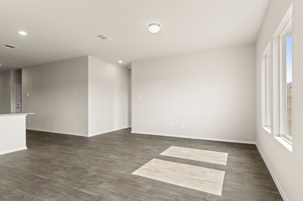 5409 Murano Cove Austin, TX 78747 - Photo 10 of 32 a view of an empty room with wooden floor and a window